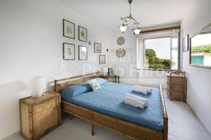 Postel nebo postele na pokoji v ubytování 6 PINETA - Porto Faro ad un passo dalla spiaggia