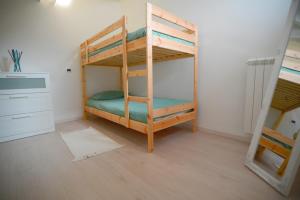 a bedroom with two bunk beds in a room at Ca' Mari in Gravellona Toce
