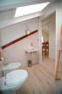 a bathroom with a toilet and a sink at Ca' Mari in Gravellona Toce