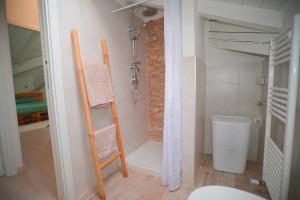 a bathroom with a towel ladder and a shower at Ca' Mari in Gravellona Toce