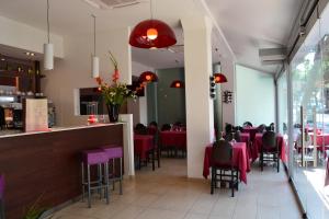 a dining room with red tables and chairs at Hotel Morena in Lido di Jesolo