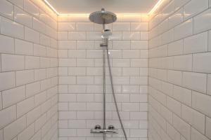 a shower in a bathroom with white tiled walls at The Hayloft in Crewe +28 photos
