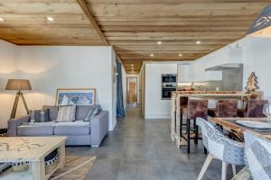 a living room with a couch and a table at Les Nards in Praz-sur-Arly +8 photos