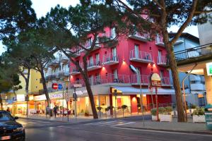 a pink building on the side of a street at Hotel Morena in Lido di Jesolo