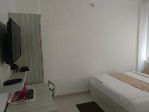 Krevet ili kreveti u jedinici u okviru objekta Sai Inn Mysore