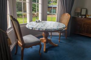 a table and chairs in a room with a window at The Old Rectory Chicklade in Chicklade