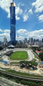 een uitzicht op een stad met een hoog gebouw bij Opus Residences Warisan Merdeka by C&C Fortune in Kuala Lumpur