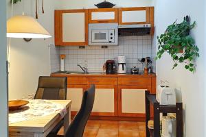 uma pequena cozinha com uma mesa e um micro-ondas em Strandstraße 16 Wohnung 06 em Kühlungsborn