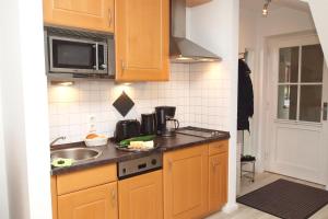 Kuchyň nebo kuchyňský kout v ubytování Strandstraße 16 Wohnung 31