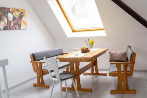 einen Esstisch und Stühle mit Oberlicht in der Unterkunft Große 3-Zimmer Maisonette Wohnung in Neuhausen in Neuhausen