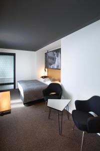 En eller flere senge i et værelse på Zoom Hotel