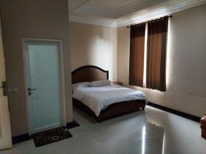 Postel nebo postele na pokoji v ubytování Mumtaz Syariah Homestay