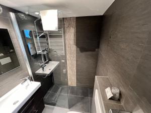 a bathroom with a sink and a tub and a mirror at Best Western Hotel Royal Centre in Brussels