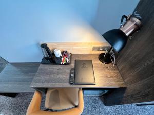 a desk with a lamp and a laptop on it at Best Western Hotel Royal Centre in Brussels