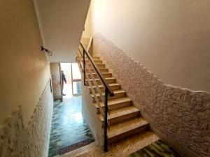 a staircase in a house with a stone wall at Casa Malù in Fiumicino