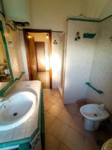 a bathroom with a sink and a toilet at Casa Malù in Fiumicino