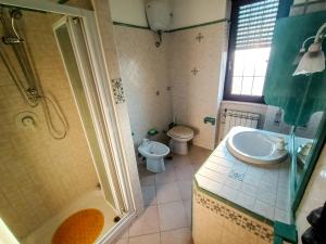 a bathroom with a shower and a sink and a toilet at Casa Malù in Fiumicino