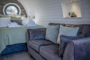 a living room with a couch and a bed at Bracken Burrows - 1 Bedroom Pod - New Hedges in New Hedges +15 photos