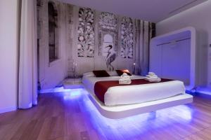 a bedroom with a large white bed with lights on it at Trevi Elite Rome in Rome