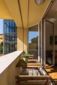 a balcony with a table and a potted plant on it at Casa Selleri in Bologna
