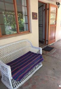 a white bench sitting in front of a building at 34 Steyn Street, Barrydale in Barrydale