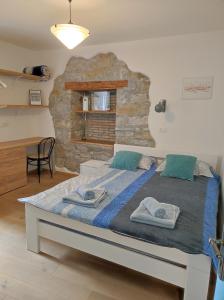 a bedroom with a large bed with towels on it at Nono Mario - Marin in Piran