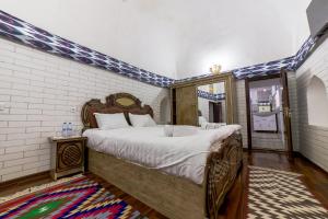 Voodi või voodid majutusasutuse Feruzkhan Hotel - Madrassah Mohammed Rakhim Khan 1871 toas
