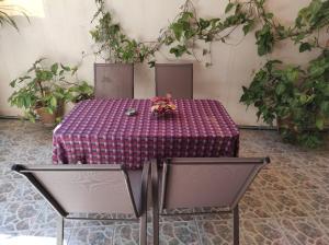 a table with two chairs and a table with flowers on it at George's & Amalia's appartments in Afantou