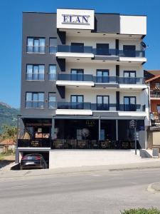 a tall building with a car parked in front of it at Elan Luxury Apartments & Rooms in Plav