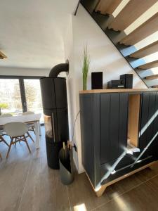 a living room with a black cabinet and a table at The Red One Edersee in Bringhausen