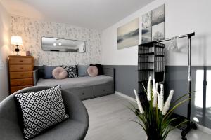 a living room with a couch and a chair at Apartament Spytkowice - 8 km od ENERGYLANDIA - ZATOR in Spytkowice