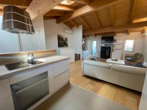 a kitchen and living room with a couch and a table at Casa Calle Pescheria in Grado