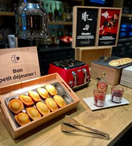 una caja de donuts sentada sobre una mesa en ibis Nuits Saint Georges, en Nuits-Saint-Georges