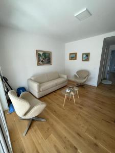 a living room with a couch and a table at Sea Gem Apartment in Dhërmi
