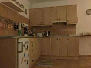a kitchen with wooden cabinets and a refrigerator at Fisherman s Cove in Costa Calma +49 photos