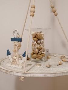 a toy boat on a table with shells on it at Fisherman s Cove in Costa Calma