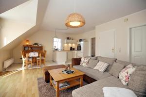 a living room with a couch and a table at Wiesengrund 9a Wohnung Bornholm in Wittenbeck