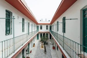 an empty corridor of a building with plants at Modern and wide- 1Bd 1Bth- Triana in Seville