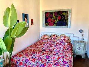 a bedroom with a bed and a painting on the wall at Lovely cosy Art flat át city center in Budapest
