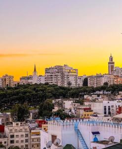 a view of a city skyline at sunset at Tangier Kasbah Hostel in Tangier