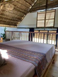 
A bed or beds in a room at Three Little Birds Resort
