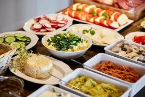 a table full of different types of food on plates at Kurort Stara Wędzarnia in Gdańsk