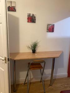a wooden desk with a potted plant on a wall at SureScape House in Liverpool