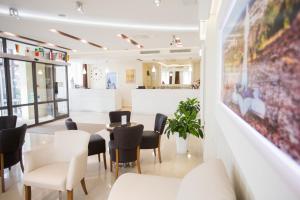 a waiting room with a table and chairs at Hotel Luna in Međugorje