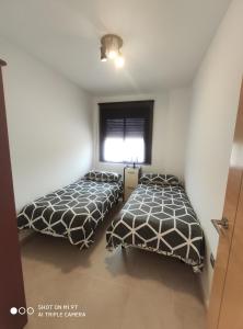 Posteľ alebo postele v izbe v ubytovaní Apartamento Castillo Bajo