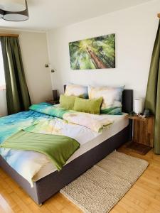 a bedroom with a large bed with a painting on the wall at Da Eni in Müstair