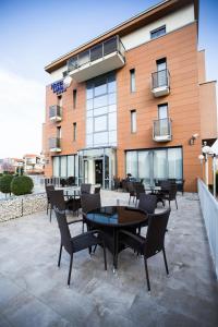 a patio with tables and chairs in front of a building at Hotel Luna in Međugorje