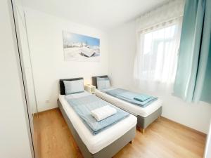 
a bedroom with a bed and a desk at Apartments ALPsmart in Oetz
