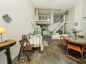 a living room with a table and a staircase at Kypri Apartments in Kipri