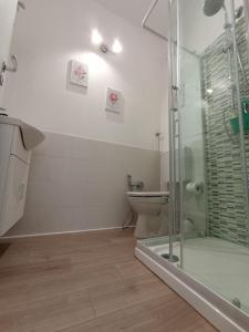 a bathroom with a toilet and a glass shower at B&B Bel Fiore in Ancona